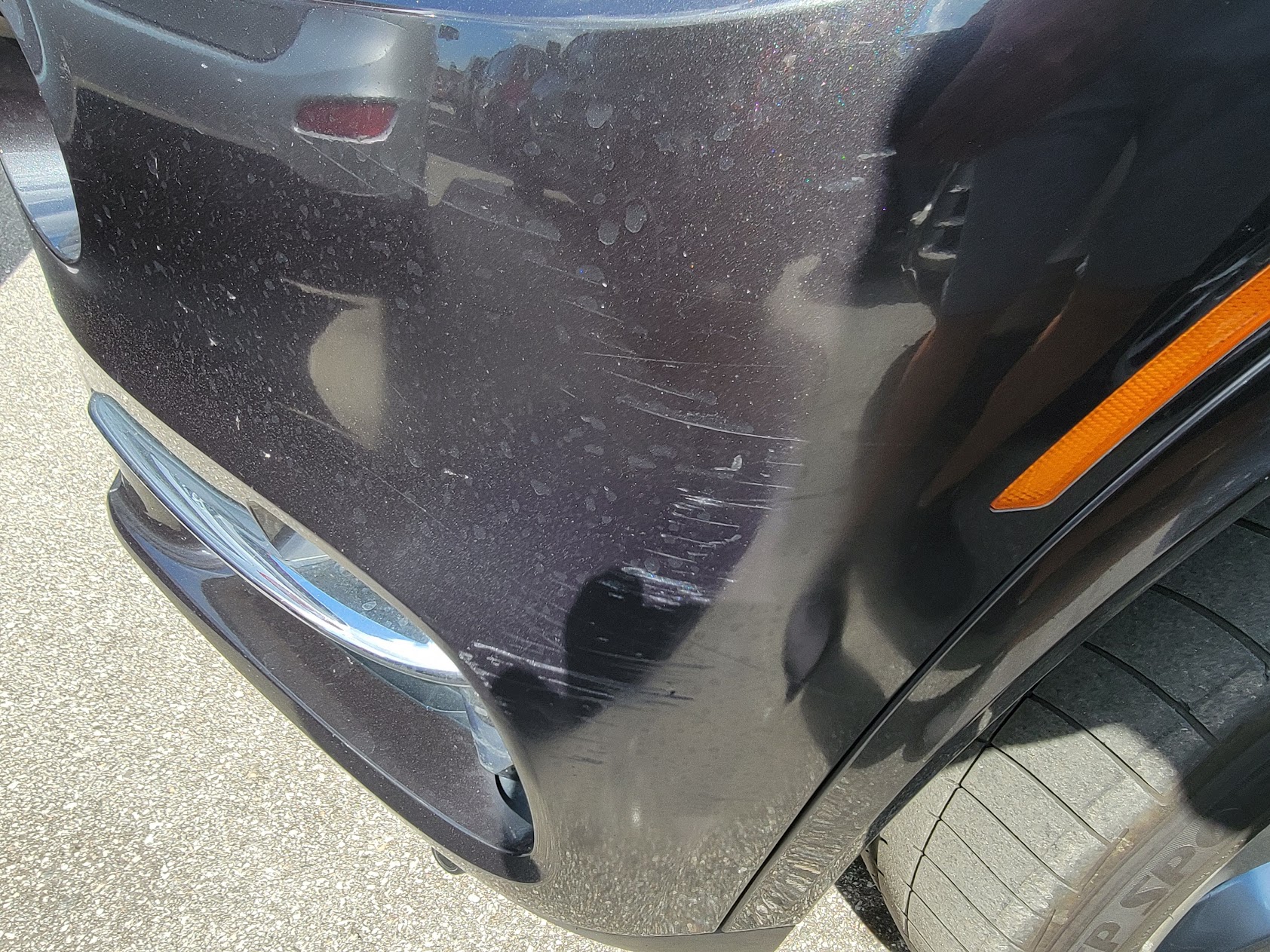 Close-up of scratches on a rear bumper